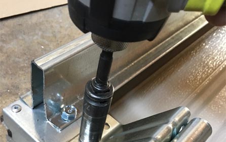 Garage Door Repairs San Diego - A picture of drilling a garage door
